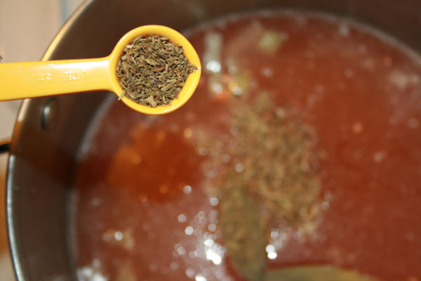 adding the thyme to the soup