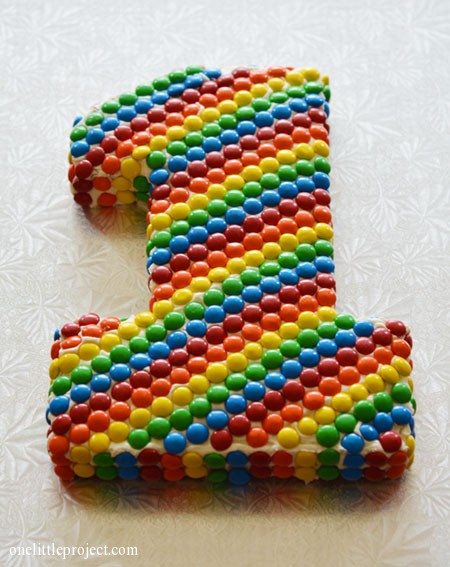 Rainbow M&M's first birthday cake | onelittleproject.com