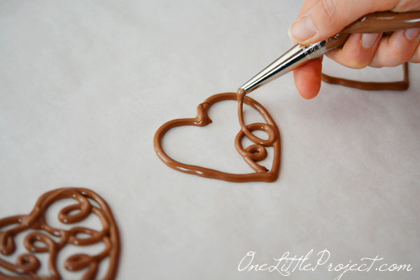 Here's an easy way to make chocolate filigree hearts. These would make the cutest cupcake toppers!