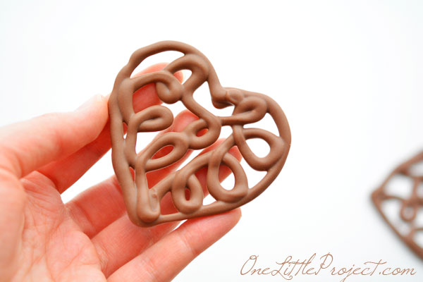 Here's an easy way to make chocolate filigree hearts. These would make the cutest cupcake toppers!