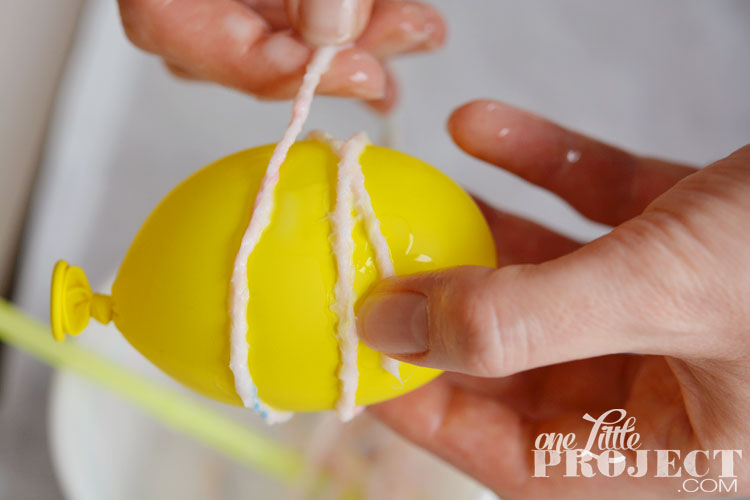 DIY Yarn Eggs - Dip the yarn in glue and it hardens over the balloon and the chocolate treats stay neatly inside!