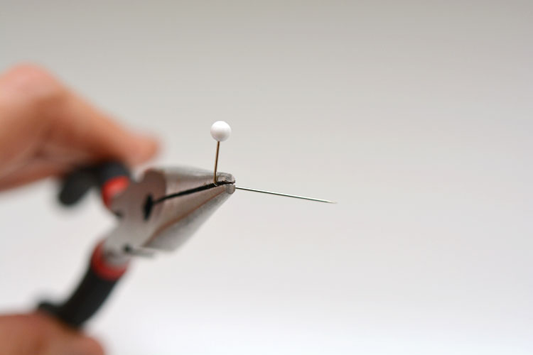 Sewing needle bent 1/2 inch from the ball