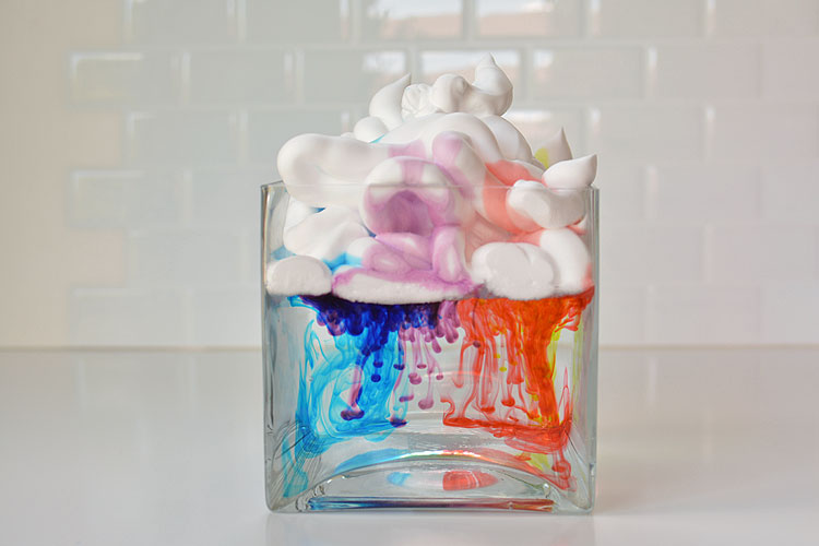 These shaving cream rain clouds were a fun, easy and beautiful activity to do with kids. Watch as the "rain" falls down from the clouds!