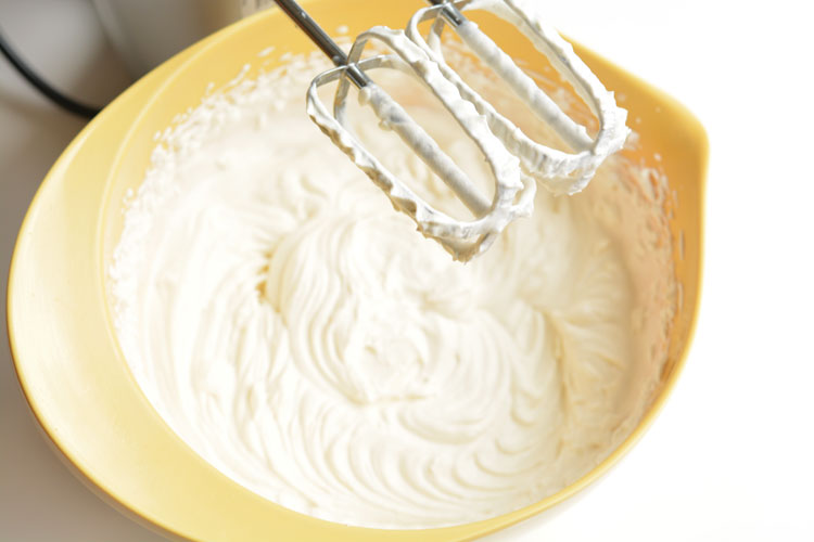Bowl of whipped cream for chocolate eclair cake