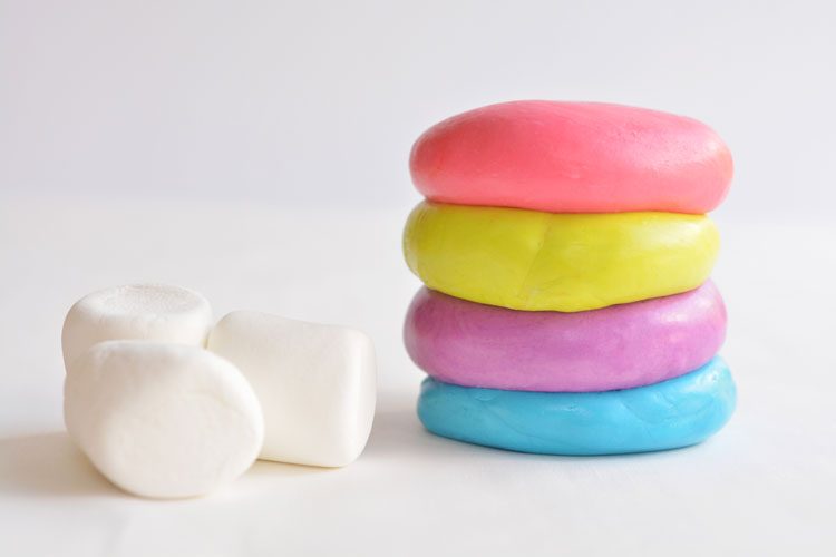 4 colours of marshmallow play dough sitting on top of one another beside 3 marshmallows