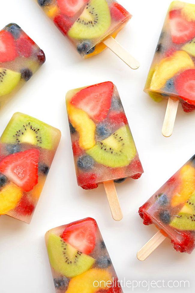 Real fruit popsicles on white surface