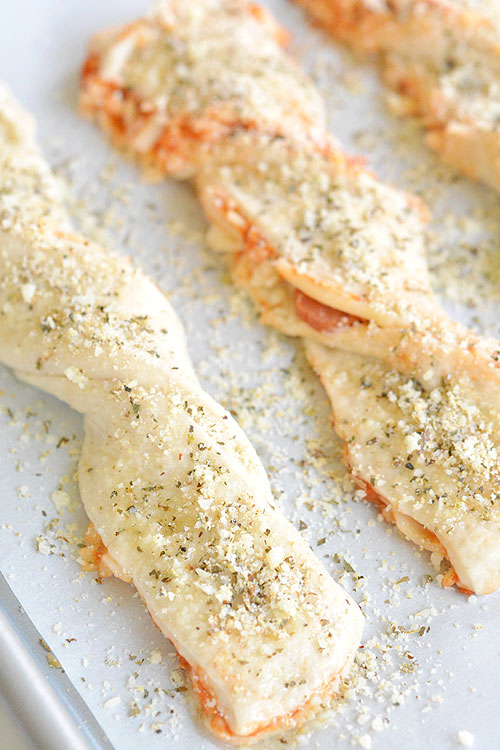 These twisted pizza breadsticks are delicious and they're so easy! They're loaded with cheesy pizza goodness! They make an impressive appetizer or snack and only take about 20 minutes to make.