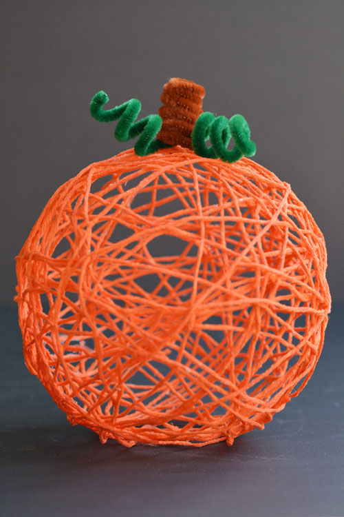Orange yarn pumpkin on a dark background