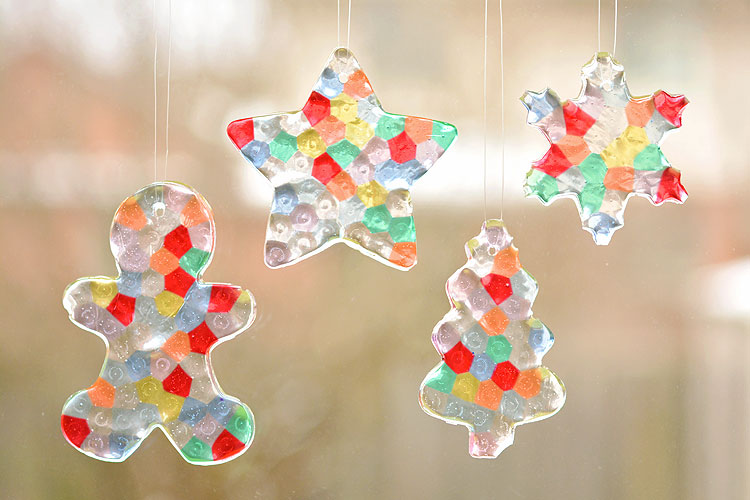 These melted bead ornaments are SO BEAUTIFUL! And they're so easy to make with pony beads! You can hang them on the Christmas tree, or use suction cup hooks on the window to turn them into sun catchers.