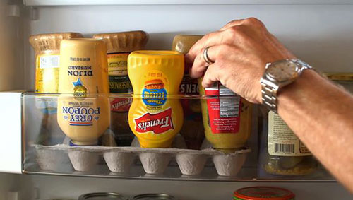 25 Hacks to Organize your Fridge - Store your condiment bottles upside down in egg cartons