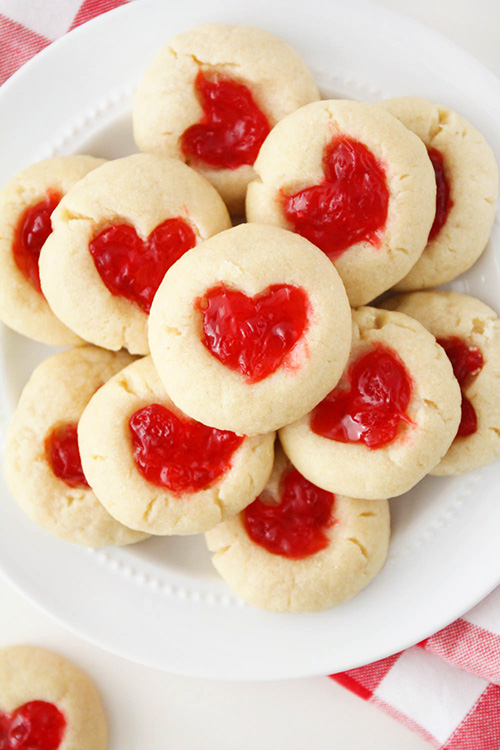 These rich and buttery gummy bear heart cookies have a sweet and chewy candy center and a simple shortbread base. They're so delicious and adorable too!