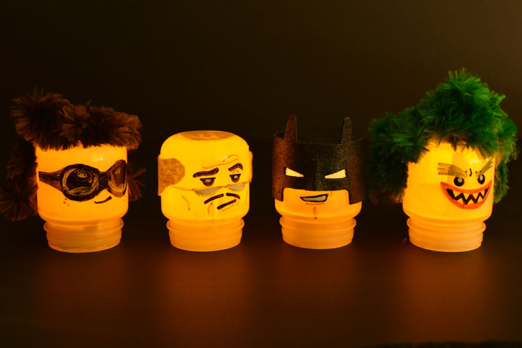 Baby food jars are the exact same shape as LEGO heads!!! Just draw on the faces and paint the jars! These Lego Batman night lights are SO CUTE! What a fun little project!