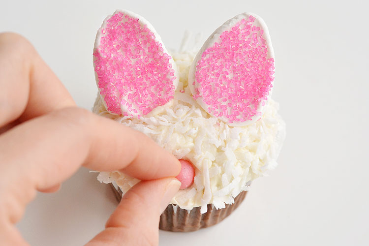 These Easter bunny cupcakes are SO ADORABLE! And they are so simple to make! Those marshmallow ears are just brilliant, and I love the coconut fur! Such a fun idea for an Easter treat, or even a spring birthday party!