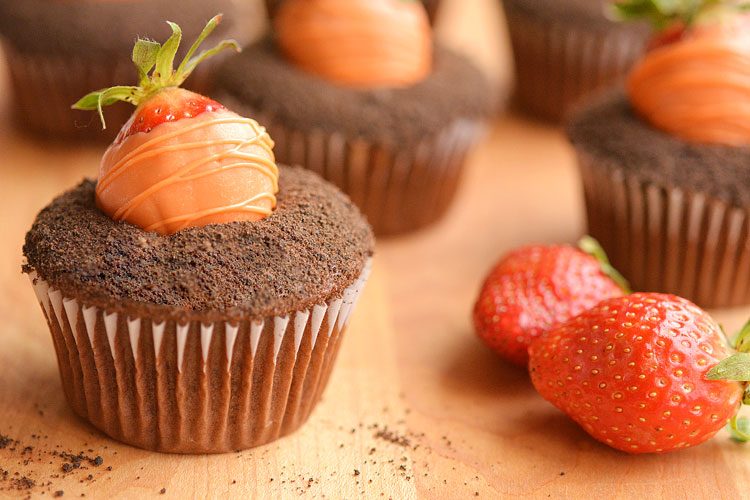 Carrot patch cupcakes with a strawberry carrot