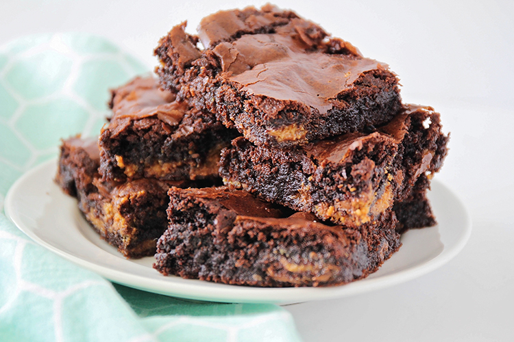 These rich and fudgy Reese's brownies are chocolate and peanut butter perfection! They're loaded with Reese's candies, and so decadent and delicious!