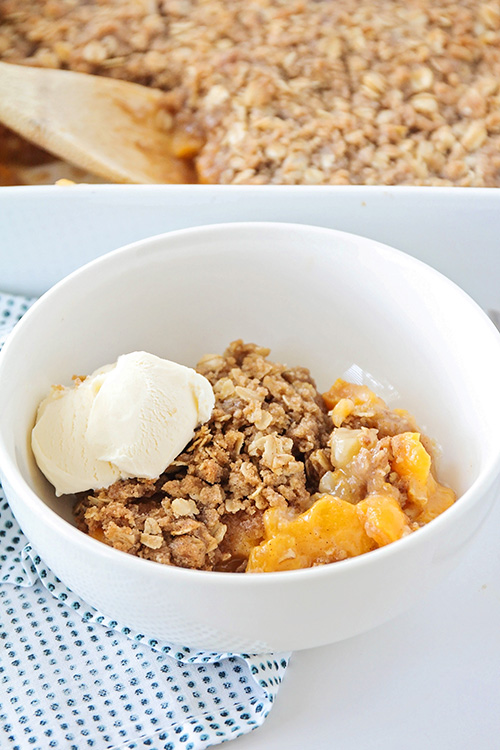 This sweet homemade peach crisp is bursting with juicy peaches, and topped with a delicious and crisp oatmeal crust for an unforgettable dessert!