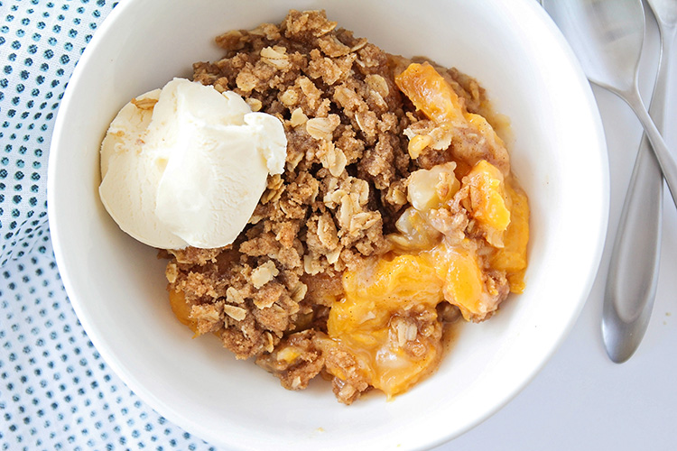 This sweet homemade peach crisp is bursting with juicy peaches, and topped with a delicious and crisp oatmeal crust for an unforgettable dessert!