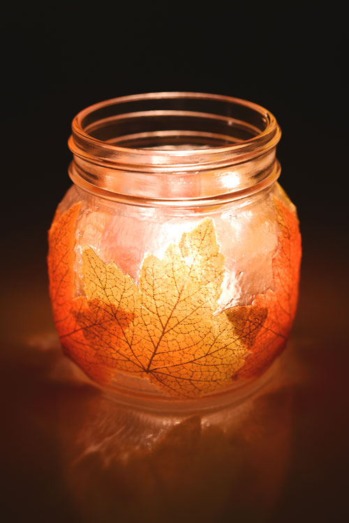 Mason jar leaf lantern lit in the dark