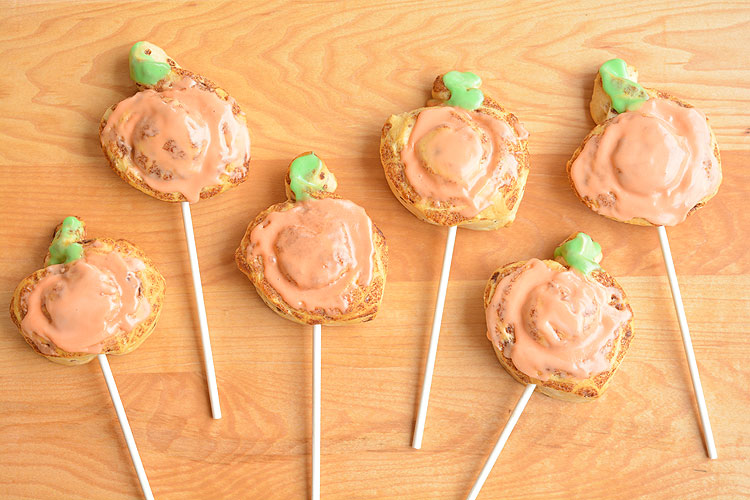 These cinnamon roll pumpkin pops are super easy, FAST, and kids absolutely LOVE them! This is such a fun dessert or snack idea for Halloween or Thanksgiving! You can whip up a batch in less than 20 minutes!