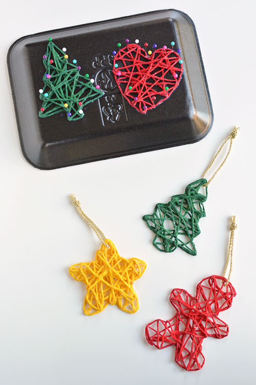 These wrapped yarn ornaments are SO PRETTY and they're so fun to make! Using yarn, glue, sewing pins and styrofoam trays you can make unique and beautiful homemade Christmas ornaments! They look beautiful on the Christmas tree and they make awesome gifts.