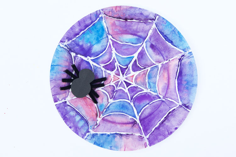 This watercolor kids art project webs use hot glue and paint to create beautiful spider webs!