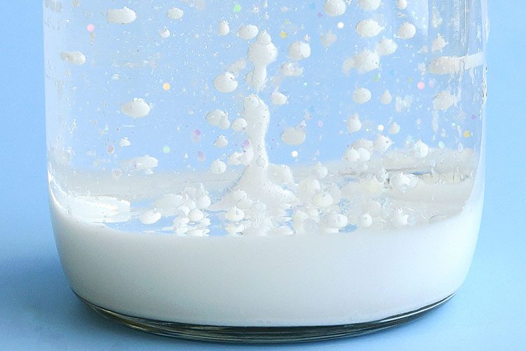 Closeup of bubbles in snowstorm in a jar experiment