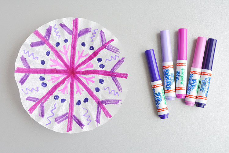 These coffee filter snowflakes are so easy to make and they are SO PRETTY! This is such a fun winter craft idea! A great activity for a snow day at home but also simple enough for teachers to make with the whole class at school. They make beautiful sun catchers and are a great Christmas decoration that can stay up all winter long! 
