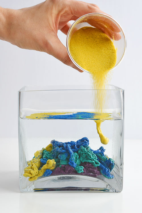 This underwater magic sand is SO COOL! This is such a fun science experiment to try with the kids! It's simple to put together, easy to clean up and you can use the sand again and again. Making your own waterproof, aqua sand is a great way to learn about science! 