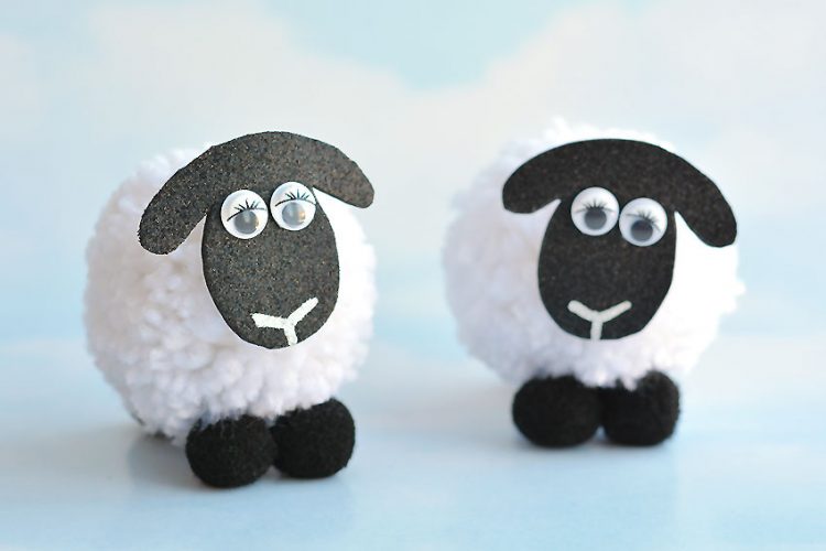 Two pom pom sheep beside each other