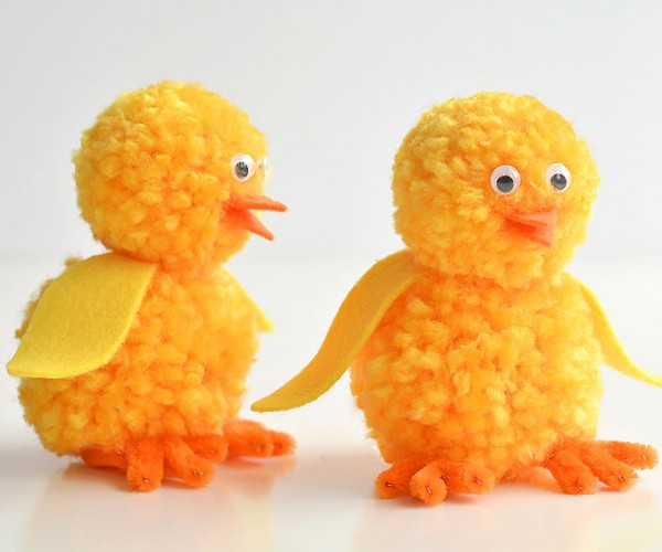 Two pom pom chicks standing beside each other