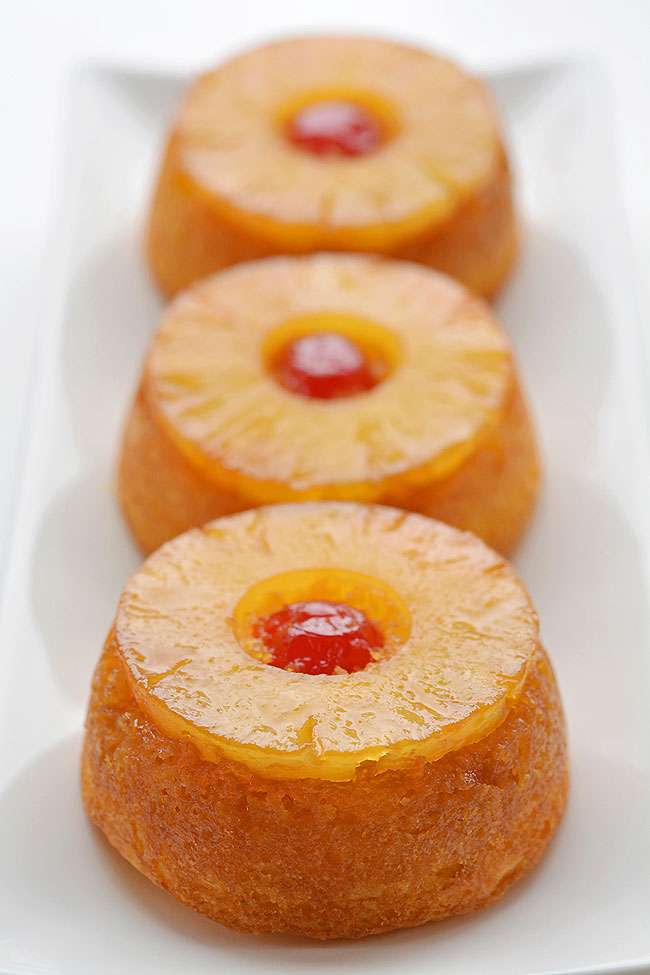 These mini pineapple upside down cakes are so pretty and they're REALLY SIMPLE to make! This is such an easy dessert recipe that is simple enough to make at the last minute on a weeknight but beautiful (and DELICIOUS!) enough to serve to guests! That warm, gooey glaze that comes out with the pineapple is soooooo good!!