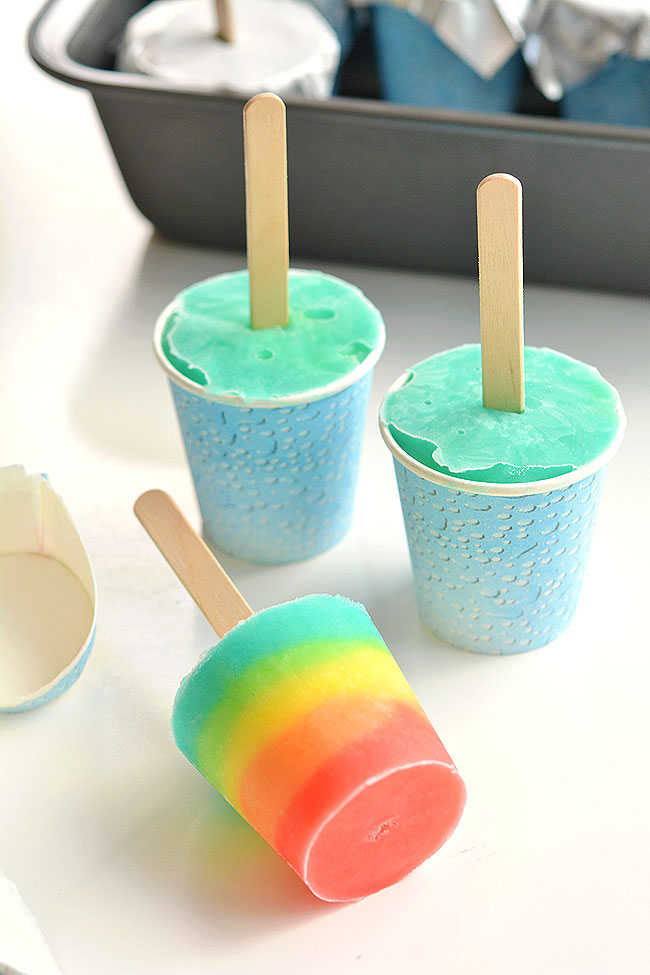 These easy rainbow popsicles are so fun and they're really simple to make! There's no need to wait for each layer to freeze which makes them quick and easy. And even better, these popsicles barely drip when they melt! This is such a great summer recipe and a super fun recipe for kids.