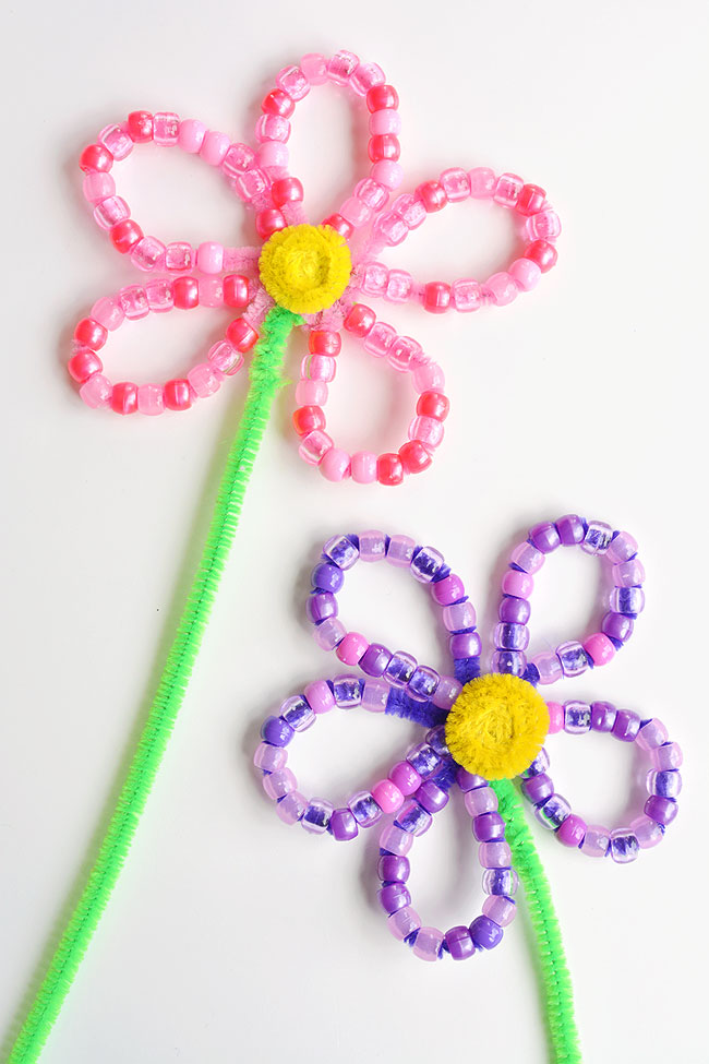 These beaded pipe cleaner flowers are SO PRETTY and they're really easy to make! This is such a fun kids craft and a great activity to develop fine motor skills. Each flower takes less than 10 minutes to make using simple craft supplies. This is a great spring craft or summer craft idea! Wouldn't they make an awesome homemade Mother's Day gift!?