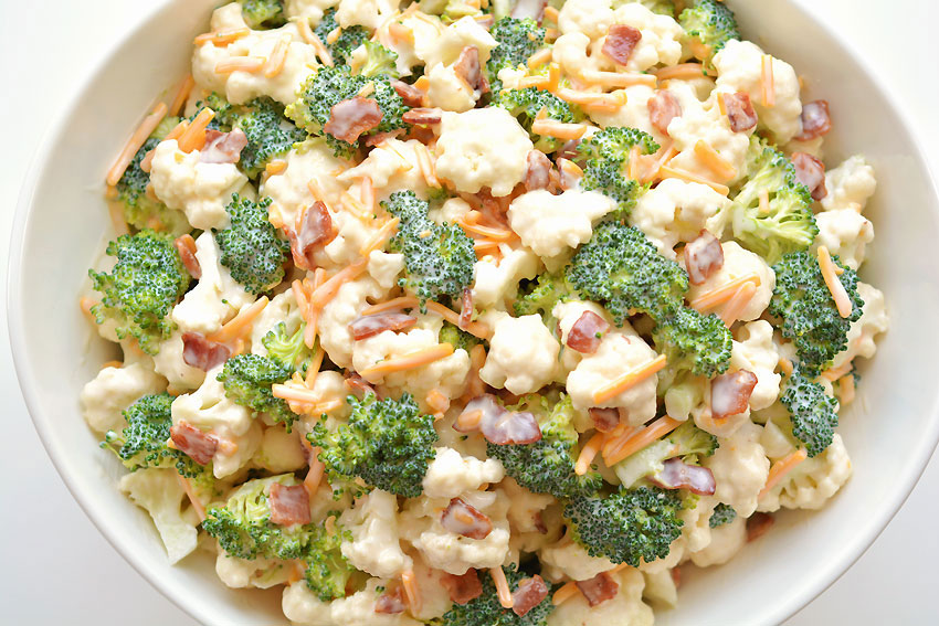 Broccoli cauliflower salad recipe in a white bowl