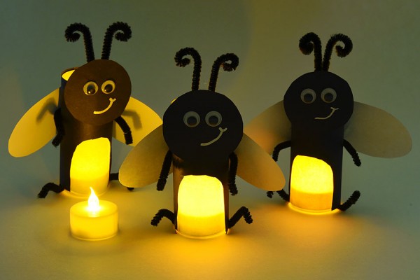 Three paper roll fireflies glowing
