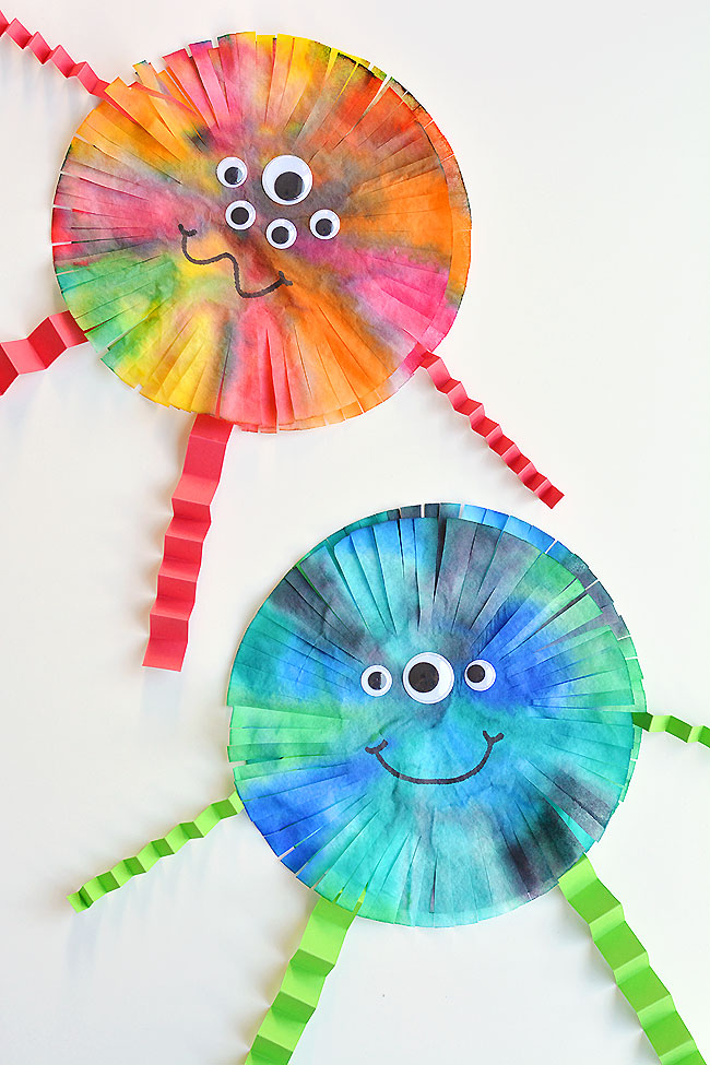 These coffee filter monsters are SO FUN to make and they look amazing! They'd look great hung up on the wall or window! This is such a fun Halloween craft for kids. It would also be a great craft for a monster themed birthday party. Such a simple way to make some non-spooky Halloween decor! With so many ways to colour and decorate, no two monsters will be exactly the same! 