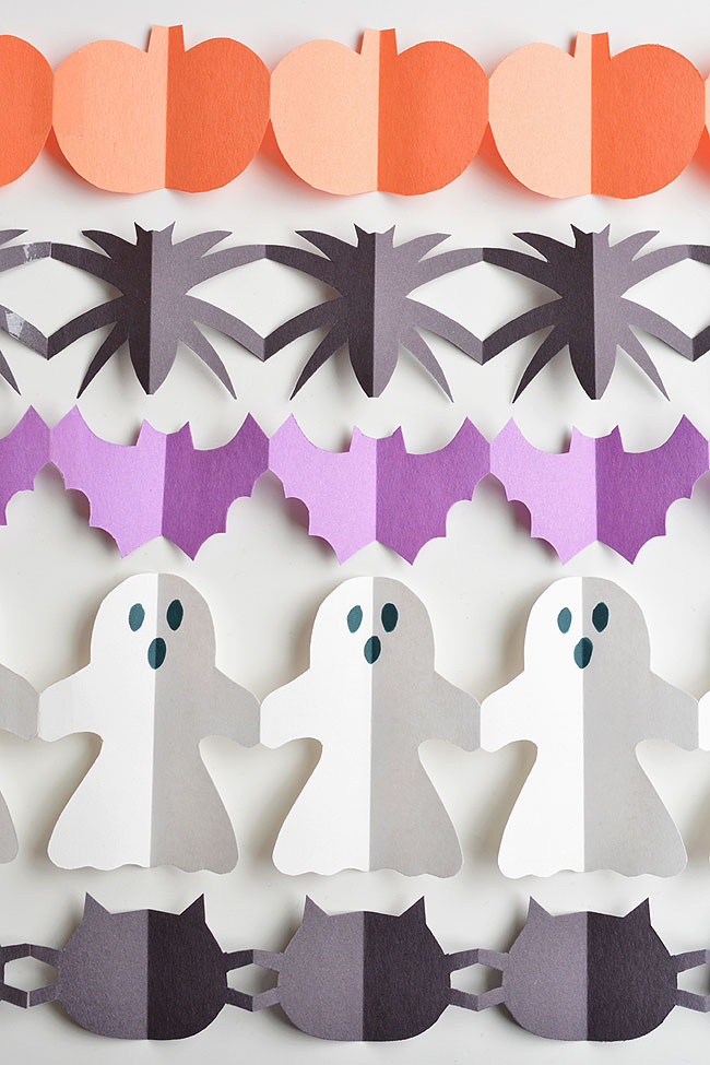 These Halloween paper garland cutouts are SO CUTE and surprisingly simple to make! This is such a fun Halloween craft for kids! Even teens, tweens, adults and seniors would have fun making them! They'd look great hung up on a door, on the walls, or even in the window! What a simple paper craft for kids and a great way to make some non-spooky DIY Halloween decor!