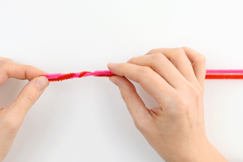 Twisting two pipe cleaners together