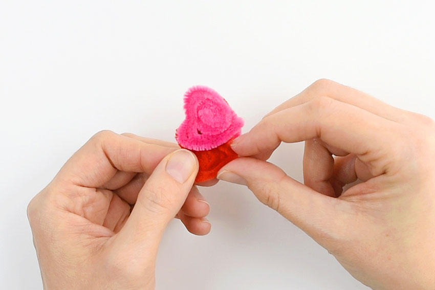 Pipe cleaner spirals being shaped into cute heart ring