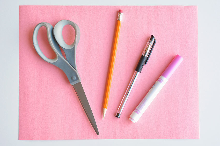 Construction paper, scissors, pencil, pen and marker