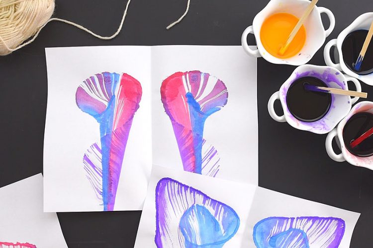 Watercolor string paintings with supplies on a black background