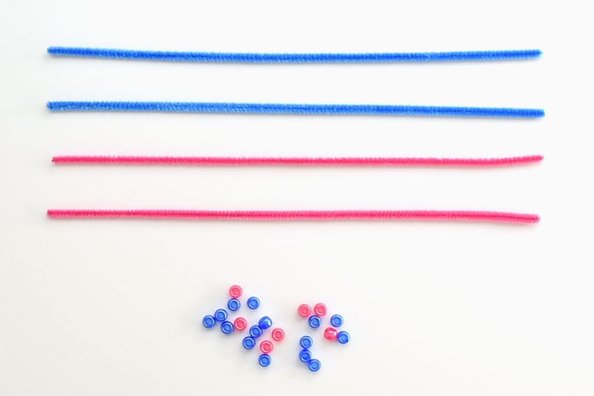 Pipe cleaners and beads on a white background