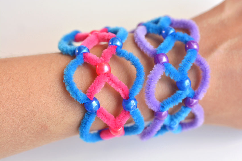 Two beaded pipe cleaner bracelets on a wrist