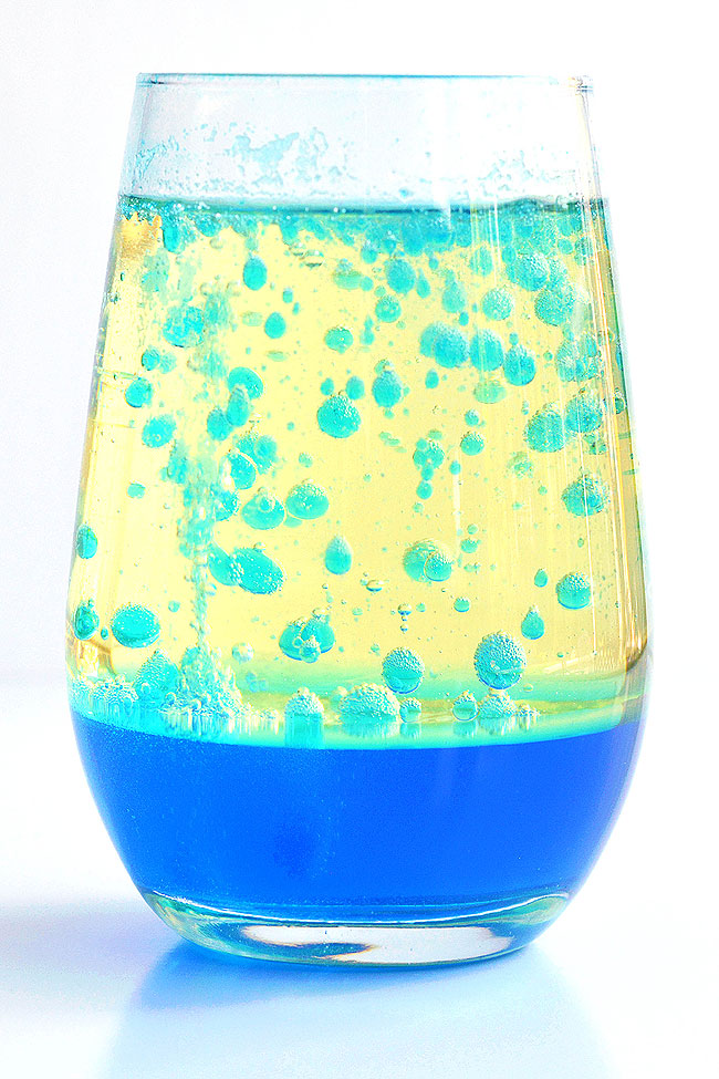 Blue lava lamp in a glass with bubbles floating in the oil