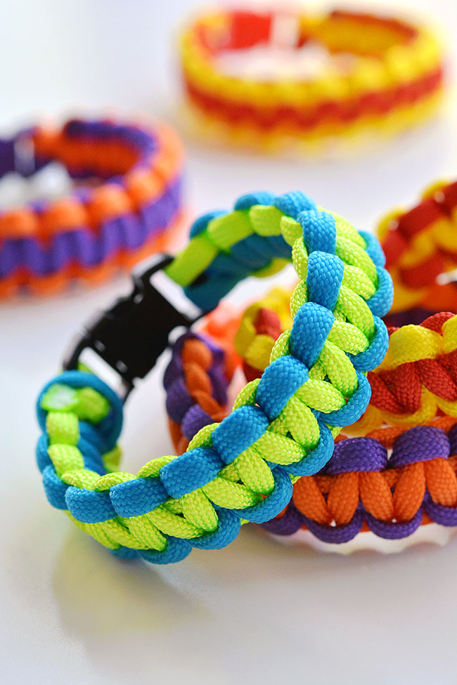 Several paracord bracelets sitting on a white background