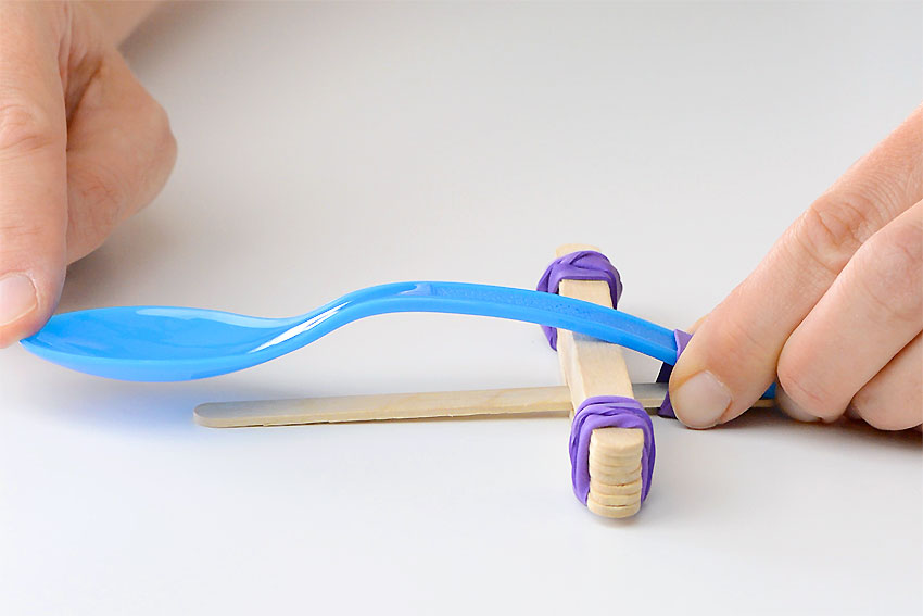 Popsicle stick catapult with the spoon held down