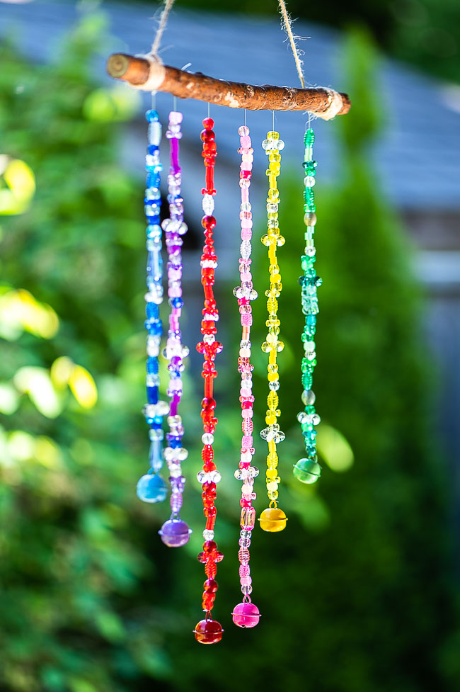 Side angle of a DIY beaded wind chime hanging outside