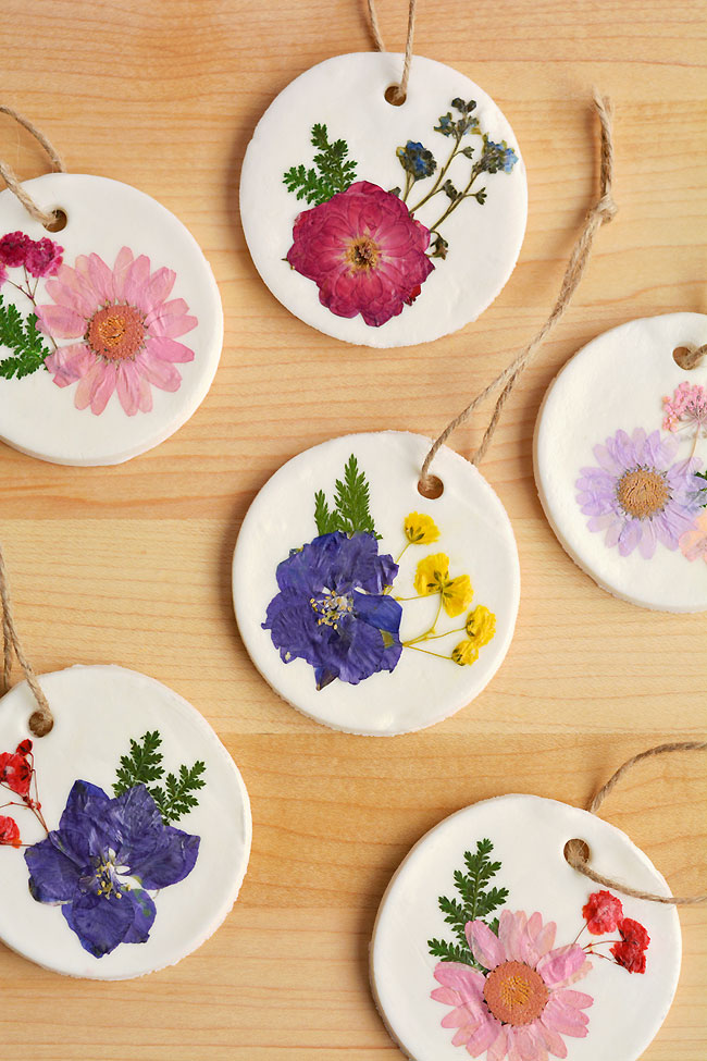 Six dried flower ornaments on a wooden background