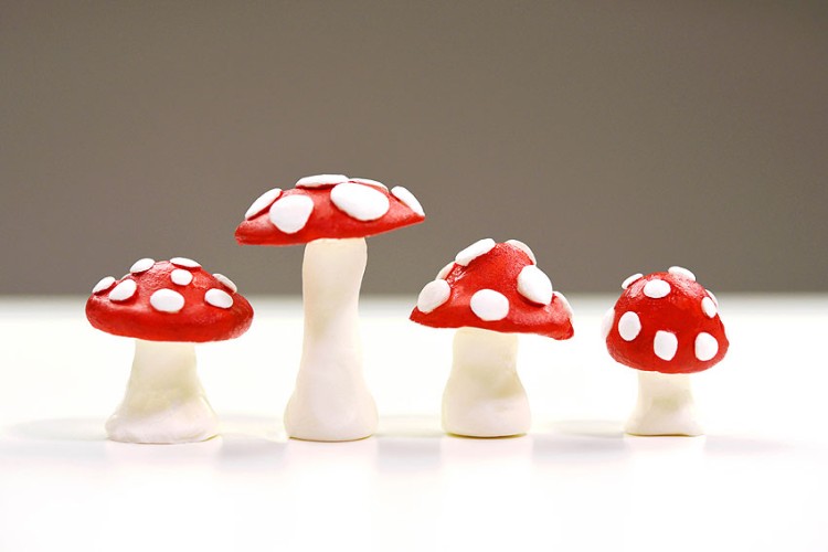 Three red capped clay mushrooms
