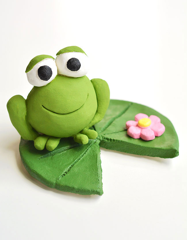 Clay frog sitting on a lily pad